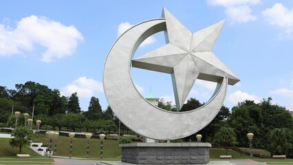 Iconic landmark of the crescent moon and star at the entrance of Istana Bukit Serene in Johor Bahru, Malaysia.