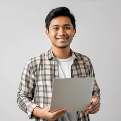 a Malay man is holding a laptop and smiling