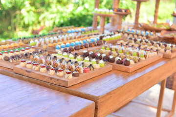 sweets, sweets on a wooden table, sweets on a wooden background, assorted sweets, party sweets, sweets table, sweets display, sweets showcase, sweet shop, daytime party, shop
