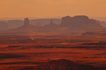 Hazy mid-afternoon view of the distant buttes and mesas of Monument Valley from Muley Point...