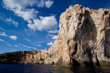 Punta Giglio promontory from the sea. Alghero, SS, Sardinia, Italy