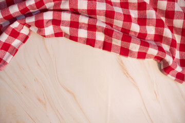 Red and white checkered tablecloth, top, crumpled, on pink marble surface, space for text