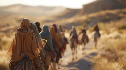 Rolgordijnen A group of nomadic people faces hidden by headscarves walk in unison with camels across the vast sp desert landscape. . . © Justlight