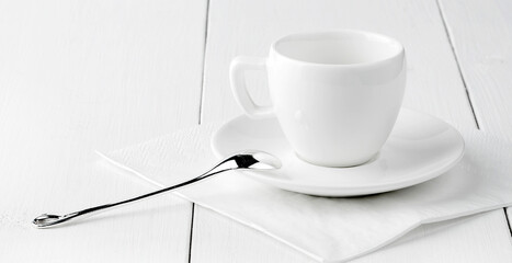 White empty coffee house cup with spoon and saucer