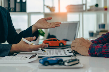 Car insurance or rental agreement or purchase or sale agreement with car keys on table Automotive...
