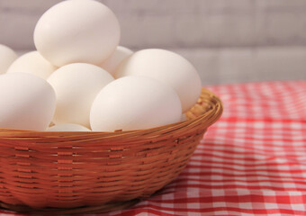 Basket of Farm Fresh Eggs on Red and White Checkered Fabric