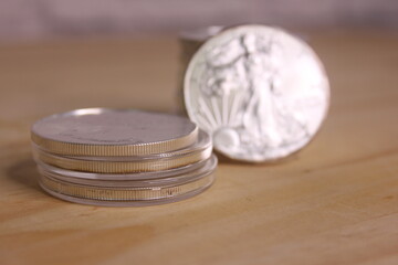 Stacks of American Silver Eagle Coins on Wooden Table