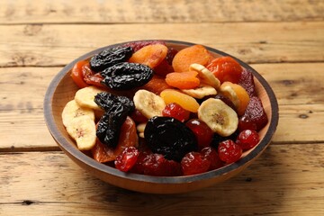 Mix of delicious dried fruits on wooden table