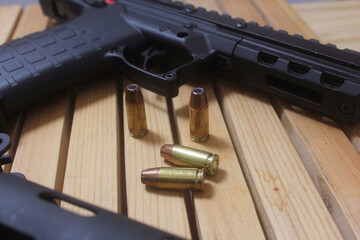 Semi Automatic Handgun on Wooden Table With Ammo