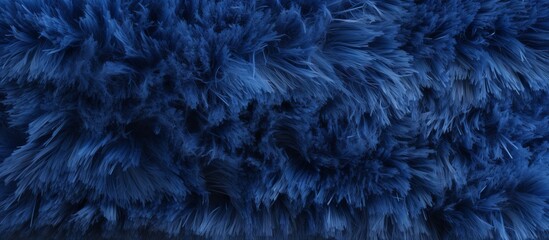 A closeup of an electric blue fur texture resembling wind waves on denim. The woolen pattern gives...
