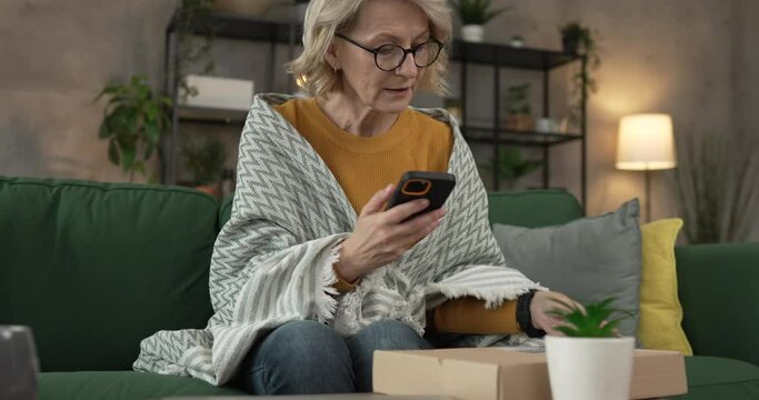 one woman checking box of received package or product at home