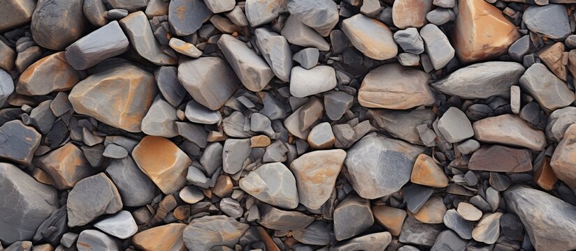A stack of cobblestone rocks, a natural composite material, sits on the ground. They could be used as building material or transformed into art pieces