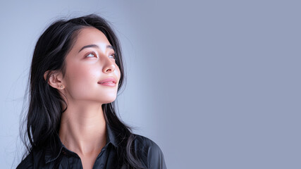 Fototapeta premium Side view of Malay businesswoman wearing black shirt, smiling candid
