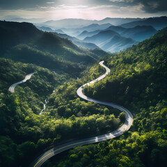 Aerial view of a winding mountain road. - obrazy, fototapety, plakaty
