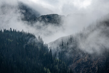 Fog in the morning in the mountain peaks in St. Juan mountains Colorado sunset rainstorm - obrazy, fototapety, plakaty