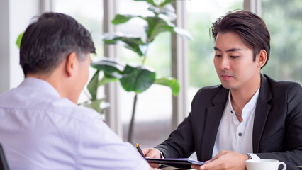 Life insurance agent selling insurance to an old man