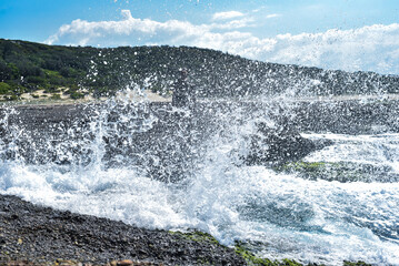 Wave breaking on a rocks at the beach