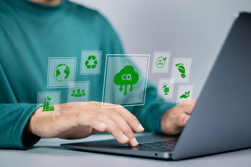 Reduce CO2 emissions concept. businessman using laptop with carbon reduction icons for climate...