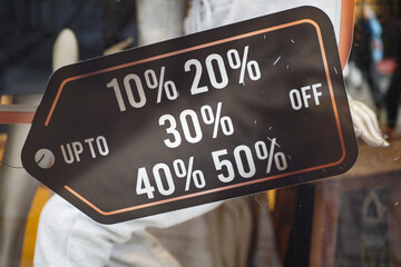 Large Sale text letters on black background on clothing store .