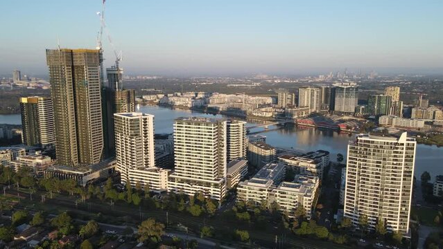 Aerial drone view of Rhodes, an Inner West suburb of Sydney, NSW Australia, turning to show Homebush Bay on a sunny morning in March 2024 