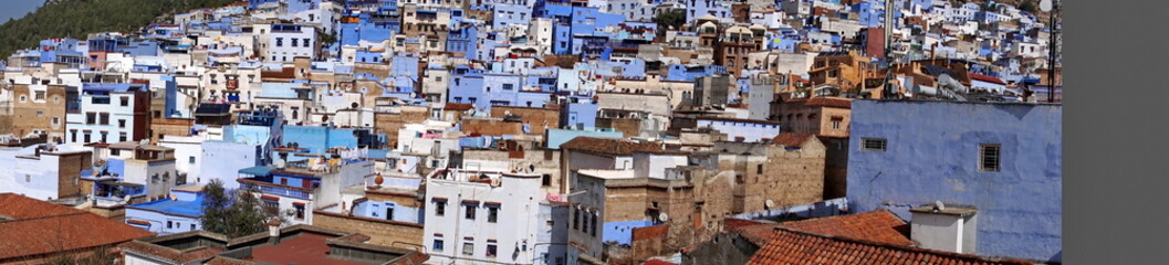 Fototapeta na wymiar Panoramam of blue and white houses in a hill in the medina, in Chefchaouen, Morocco
