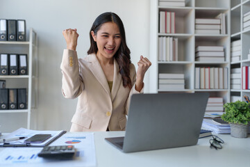 Asian businesswoman, investor showing a happy expression to know the results of financial approval...