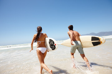 Couple, water and surfboard for surfing or running with tide check, adventure and fitness with blue...