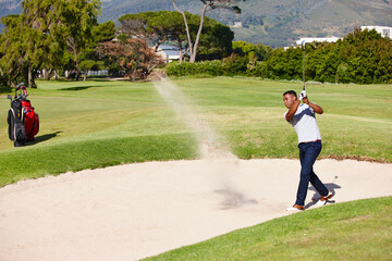 Man, golfer and swing with stroke in sand pit for par, bogey or strike with grass field in nature....
