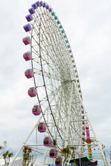 The towering Ferris wheel in urban amusement parks