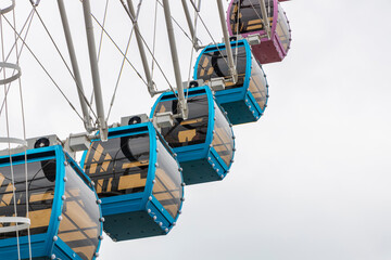 The skyscrapers in the amusement park hang high and spin in the sky