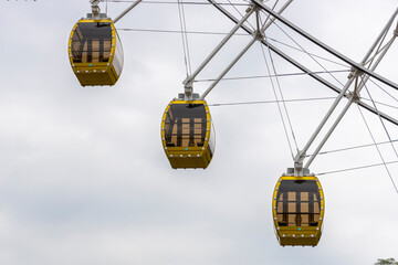 The skyscrapers in the amusement park hang high and spin in the sky