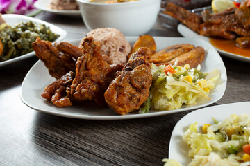 A view of a plate of Jamaican style fried chicken.