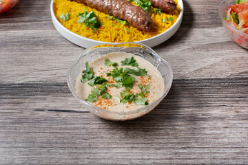 A view of a small bowl of tahini sauce.