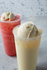 A view of a mango cream milk beverage and a strawberry cream milk beverage.