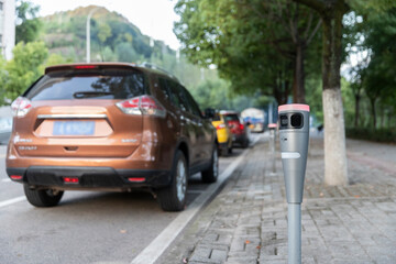 Fototapeta premium Modern intelligent parking timing and toll collection equipment, with cars parked on the roadside automatically sensing timing and toll collection