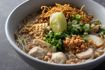 A closeup view of a bowl of street noodle.