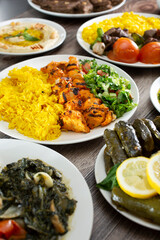 A view of a plate of chicken kebab among other Lebanese entrees.