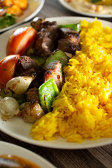 A view of a plate of beef kabobs.