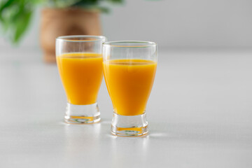 A view of two orange colored energy shots.