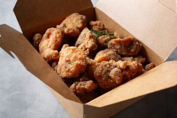 A closeup view of a container of popcorn chicken.
