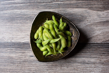 A top down view of a plate of edamame.