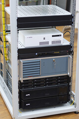 A telecommunications rack with multimedia and network electronic equipment.