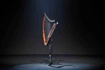 a harp is lit up on a stand with a string that says 