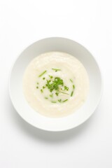 A bowl of congee on white background overhead view.