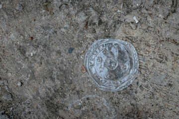 Discarded Plastic Lid on Urban Ground