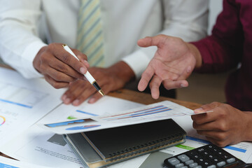 Asian business advisor meeting to analyze and discuss the situation on the financial report in the...