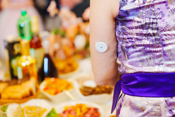 Sugar monitoring sensor on the shoulder. An insulin pump.