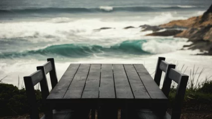 Draagtas pier on the beach An empty dark wooden table positioned against a backdrop of crashing waves and rocky cliffs, dynamic interplay of light and water, © Aliakbar