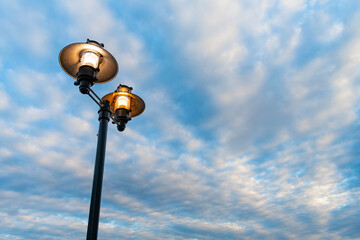 Streetlamp street lamp on the background of cloudy sky with copy space for banner advertisement