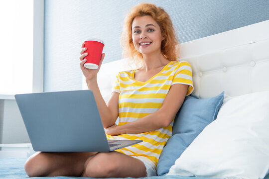 communication of glad woman with coffee and laptop. online communication of woman at home.